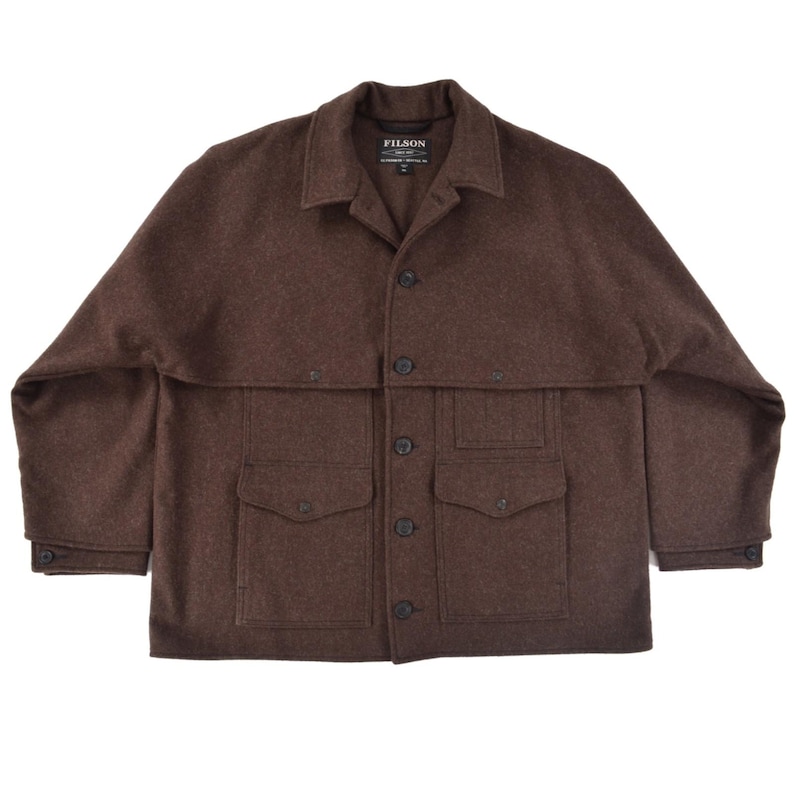May include: A brown wool jacket with a button-up front, two chest pockets, and two lower pockets. The jacket has a collar and buttoned cuffs. The brand "FILSON" is visible on a tag near the collar.