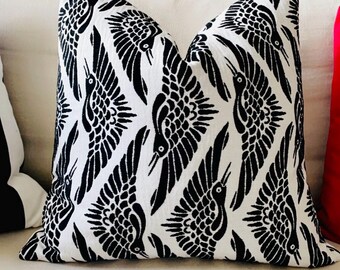 May include: Black and white throw pillow with a repeating pattern of stylized birds. The birds are facing different directions and have a geometric design.