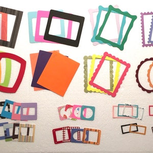 May include: Assortment of colorful paper frames in various shapes and sizes, including square, rectangle, oval, and circle. The frames are made of cardstock and have a variety of patterns and textures.