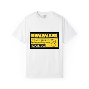 May include: White t-shirt with a black and yellow graphic. The graphic reads "REMEMBER" in yellow, with the text "Turn your computer off before midnight on 12/31/99." and a mouse icon.