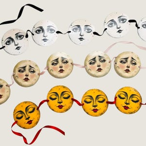May include: Three horizontal garlands featuring circular moon faces. The top row has white moons with black ink details, the middle row has beige moons with tearful expressions, and the bottom row has yellow moons with closed eyes and red lips.
