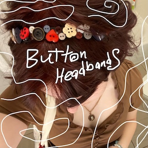 May include: A headband adorned with a variety of colorful buttons, including a red ladybug, a red heart, and flower-shaped buttons. The text "Button Headbands" is written in white across the image. The headband is worn on dark reddish-brown hair.