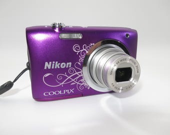 Nikon Coolpix A100 Compact Digital Camera 20.1MP, 5x Zoom purple color and in mint condition, with original box, sd card, Tested and Works