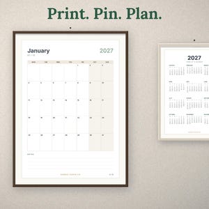 May include: Two framed wall calendars for 2027. The larger calendar shows the month of January with a grid layout and notes section. The smaller calendar displays the full year at a glance. The text Print. Pin. Plan. is centered above.