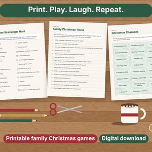 May include: Three printable game sheets titled Christmas Scavenger Hunt, Family Christmas Trivia, and Christmas Charades. Includes red, yellow, and green pencils, scissors, a mug, and three round ornaments on a wood-grain background.