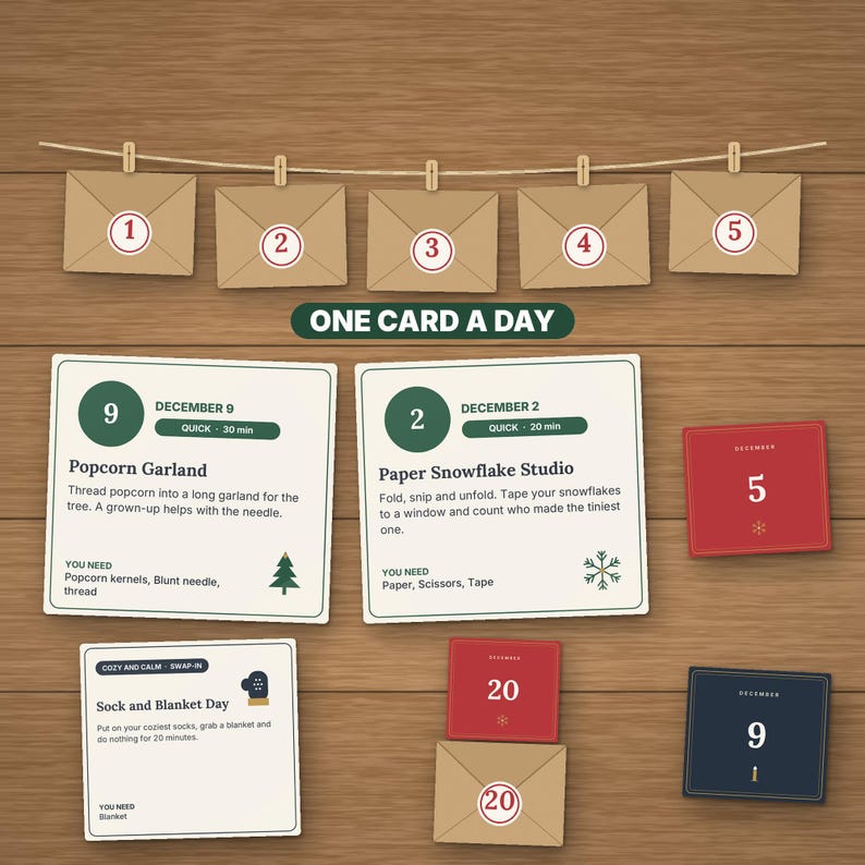 May include: A collection of activity cards and envelopes labeled One Card A Day. The cards feature instructions for December 2, 9, and 20, with tasks like Popcorn Garland and Paper Snowflake Studio. Envelopes numbered 1 through 5 and 20 are included.