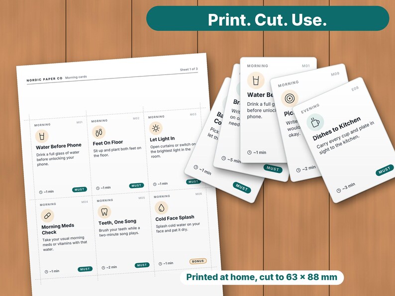 May include: A printable sheet and a stack of white cards featuring daily routine tasks with icons and text. Each card includes a time estimate and a label. The text includes phrases like Water Before Phone, Feet On Floor, and Dishes to Kitchen. The cards measure 63 x 88 mm.