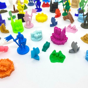 May include: A collection of colourful 3D printed miniature castles, ships, and figures. The miniatures are made of plastic and are ideal for tabletop gaming or display.