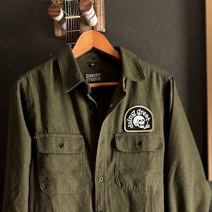 Army Green Flannel: Long Sleeve Button-Up with Sarcastic Skull Patch