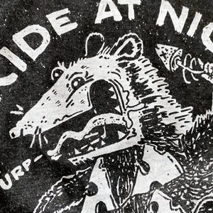 May include: Black and white graphic print of a rat with a large mouth and sharp teeth. The rat is wearing a shirt and has an arrow pointing towards it. The text "SIDE AT NIGHT" is visible above the rat.