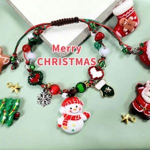 Handmade Christmas bracelet with festive charms like Snowman, Santa, Christmas tree, Teddy bear, Socks and Gingerbread.