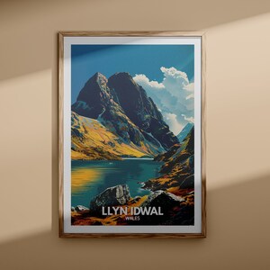 May include: A vintage travel poster featuring a scenic view of Llyn Idwal in Wales. The poster depicts a mountain lake surrounded by rugged mountains and a bright blue sky with fluffy clouds. The text "LLYN IDWAL WALES" is printed at the bottom of the poster.