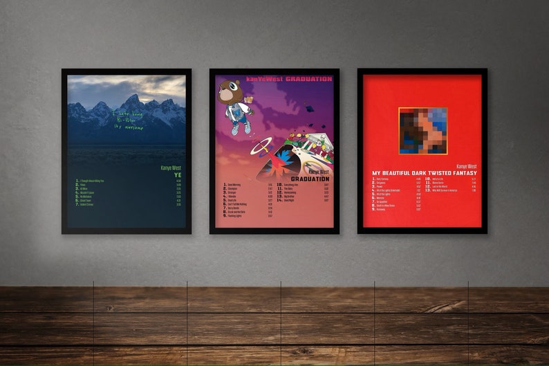 May include: Three framed album covers by Kanye West. The covers are for the albums "Ye", "Graduation", and "My Beautiful Dark Twisted Fantasy".