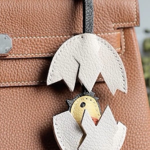 Pendentif porte-clés pour bébés animaux qui brise les coquillages