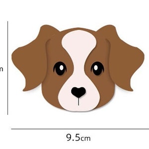 May include: A brown and white cartoon dog with black eyes and a black heart-shaped nose. The dog is 7 cm tall and 9.5 cm wide.