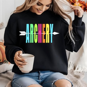May include: A black sweatshirt with the word "ARCHERY" printed in rainbow colors with a white arrow pointing to the right.