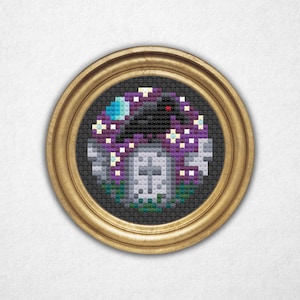 May include: A framed cross-stitch artwork featuring a spooky scene. The design includes a black crow, a purple mushroom, a tombstone, and a crescent moon. The artwork is framed in a round, gold-colored frame, and the background is white.