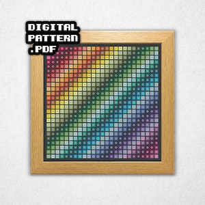 May include: A framed cross-stitch pattern featuring a gradient of colors from red to purple, arranged in a grid of small squares. The frame is made of light-colored wood. Text in the upper left corner reads "DIGITAL PATTERN .PDF".
