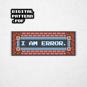 May include: A cross-stitch design with the words "I AM ERROR" in white on a black background, framed by a brick-like border. The top left corner features a black square with "DIGITAL PATTERN .PDF" in white.