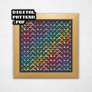 May include: A framed cross-stitch pattern with a geometric design in a variety of colors, including red, orange, yellow, green, blue, and purple. The text "DIGITAL PATTERN .PDF" is in the upper left corner. The frame is made of light-colored wood.