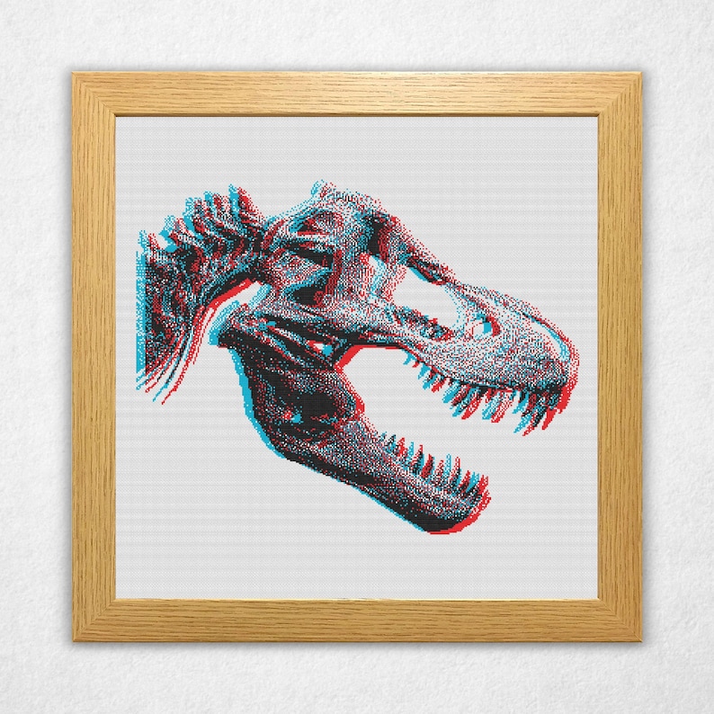 Digital rendering of a cross stitch on white aida cloth in a wooden frame of a bitmap style Tyrannosaurus rex, or t-rex, dinosaur skull in an anaglyph 3d style with cyan on the left and red on the right and offset vertically by a few stitches.