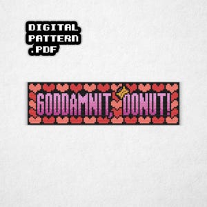 May include: A pixelated design featuring the phrase "GODDAMNIT, DONUT!" in pink and purple, framed by a border of red and pink hearts. The words are in a bold, blocky font. Above the phrase is a small graphic that says "DIGITAL PATTERN .PDF".