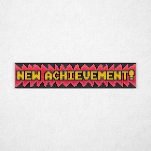 May include: A pixelated banner with the words "NEW ACHIEVEMENT!" in yellow, set against a red background with black jagged edges. The design resembles a classic video game graphic.
