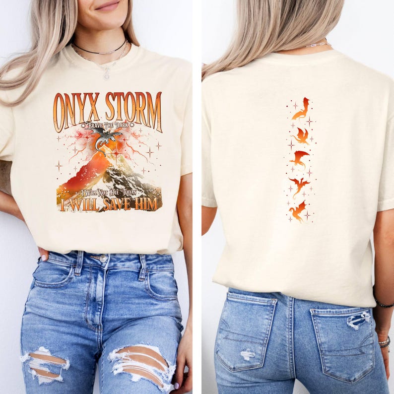 May include: A cream colored t-shirt with the text "ONYX STORM" and a graphic of a mountain with a dragon flying over it. The back of the shirt has a vertical row of five orange dragons.