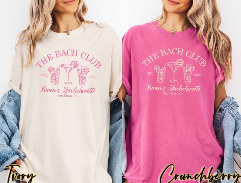 May include: Two white t-shirts with pink text that reads "The Bach Club Est. 2024 Karen's Bachelorette San Diego, CA". The shirts feature a graphic of three cocktail glasses with pink outlines.
