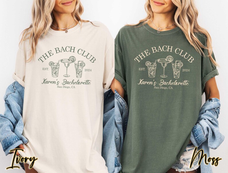 May include: Two women's t-shirts with a green and ivory color scheme. The shirts feature a graphic design of a cocktail glass with the text "The Bach Club Est. 2024 Karen's Bachelorette San Diego, CA".