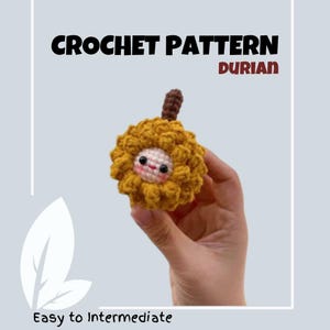 May include: Crochet pattern for a durian fruit amigurumi. The durian is yellow with a brown stem and a cute face. The pattern is described as easy to intermediate.