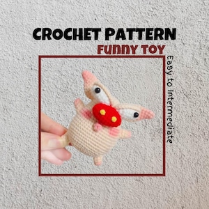May include: Crochet pattern for a funny toy. The toy is a pink and white crocheted creature with a red nose and yellow eyes. The pattern is described as easy to intermediate.