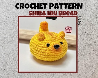 May include: A crochet pattern for a Shiba Inu bread, a cute yellow crocheted dog-shaped bread with black eyes and nose. The pattern is labeled "Easy" and features a red stamp with the Chinese character for "fortune".