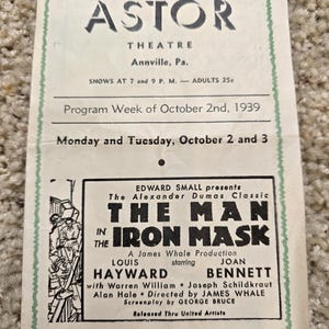 May include: A black and white movie poster for the film "The Man in the Iron Mask" starring Louis Hayward and Joan Bennett. The poster advertises a showing at the Astor Theatre in Annville, Pennsylvania on October 2nd and 3rd, 1939.