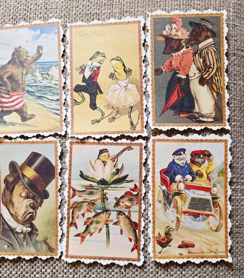 May include: A collection of vintage-style postcards featuring anthropomorphic animals in various scenes. The cards depict a bear at the beach, frogs dancing, bears and dogs in formal attire, a bulldog in a top hat, a frog playing a lute, and animals in a car.