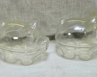 Par de contenedores vintage de plástico transparente con forma de cerdo para dulces