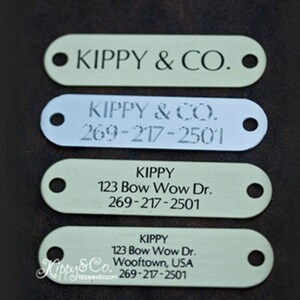 May include: Four different dog tag designs with the name "Kippy" and the text "Kippy & Co."  The tags are made of metal and have a hole for a ring. The phone number 269-217-2501 is included on three of the tags.