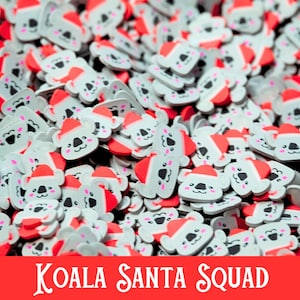May include: A large pile of gray koala bear charms with red Santa hats. The charms are all facing forward and have a smiling expression. The text "KOALA SANTA SQUAD" is printed in white on a red background at the bottom of the image.