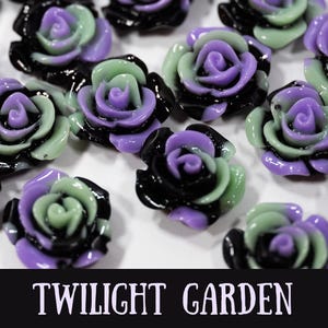 May include: Close-up of multiple resin rose beads in shades of black, purple, and green. The roses are arranged on a white surface. The text "TWILIGHT GARDEN" is displayed at the bottom of the image.