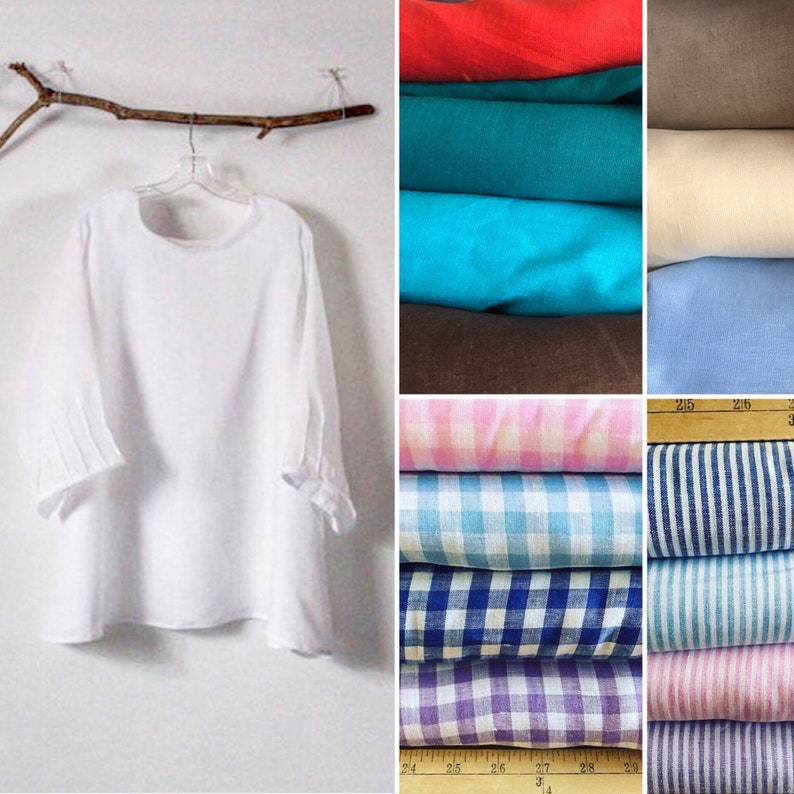 May include: A white linen tunic with three-quarter sleeves hangs on a clear hanger. The sleeves have pleated details at the cuffs. To the right are stacks of colorful fabrics in various solid colors, checks, and stripes.