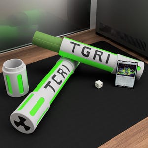 May include: White and green cylindrical containers with the text "TGRI" and "TCR)" printed on them. A die and a card are next to the containers. The containers have a green accent colour and a radiation symbol on the end.