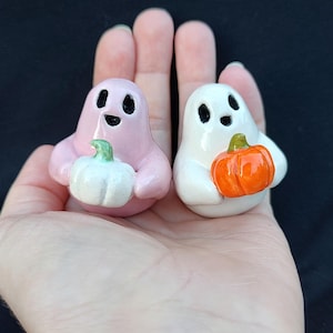 ghosts holding pumpkins, happy ghosties, ceramic ghost figurines with pumpkins, Halloween decor, cute, tiny, ghost sculptures, fall decor