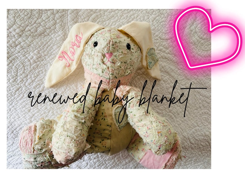 May include: A handmade bunny-shaped baby blanket with floral fabric and pink accents. The bunny's ear is embroidered with the name "Nora" in pink script. The blanket has the words "renewed baby blanket" in a handwritten font.