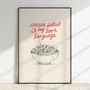 May include: A white poster with black text that reads "caesar salad is my love language" in red. A black and white illustration of a bowl of caesar salad is below the text.