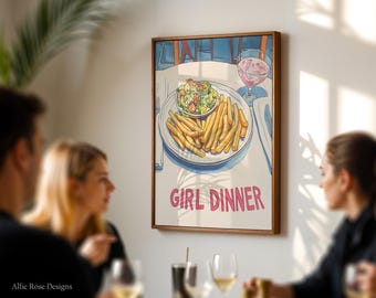 Könnte beinhalten: Ein gerahmter Kunstdruck mit einer Aquarellillustration eines Tellers Pommes Frites und Salat, dazu ein Glas Roséwein. Die Worte "GIRL DINNER" stehen in rosa Schrift. Das Kunstwerk wird in einem Esszimmer gezeigt.