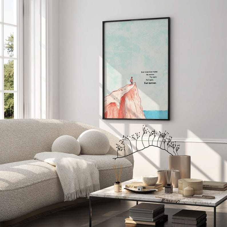 Digital illustration of a person standing at the edge of a red cliff, gazing out over the ocean under a soft blue sky. The right side of the artwork features the famous motivational quote: “Ever tried. Ever failed. No matter. Try again. Fail again. Fail better.” in bold text. This inspirational digital wall art encourages resilience and is perfect for printing and displaying in offices, dorm rooms, or therapy spaces as a reminder to persevere.