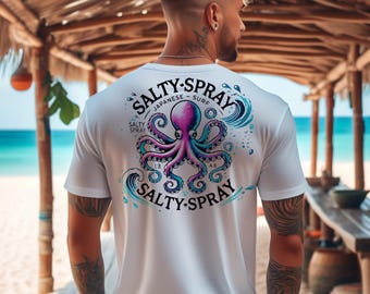 May include: White t-shirt with a colorful octopus graphic on the back. The octopus is purple and blue, with the words "SALTY-SPRAY" and "JAPANESE - SURF" in a circular design above it. The shirt is being worn on a beach.