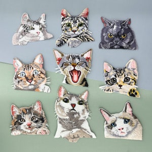 May include: Ten embroidered iron-on patches featuring different cat designs. The patches are in various colors, including black, white, gray, brown, and orange. The cats are depicted in various poses, including sitting, standing, and lying down.