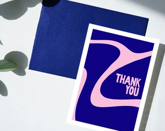 May include: A blue and pink thank you card with a modern abstract design. The card has a white border and the words "Thank You" are printed in pink.