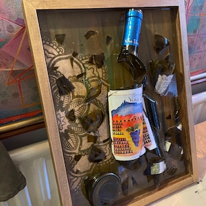 broken red wine bottle set in resin